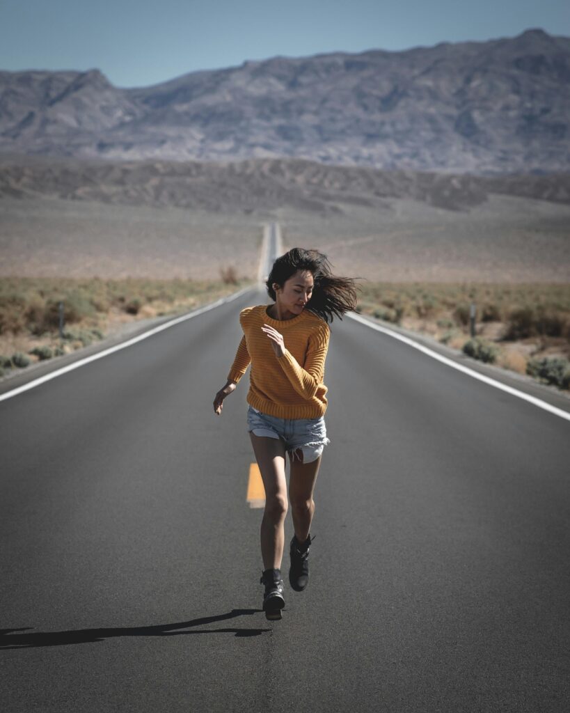 Running on a road with a mountain in the background, enjoying the freedom of not wearing glasses.